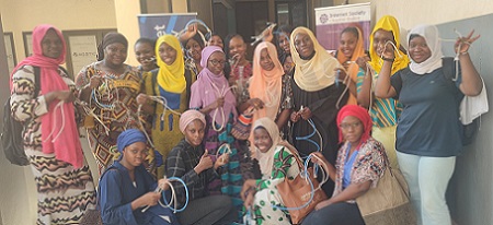 Un groupe de femmes posant pour une photo avec des câbles dans leurs mains